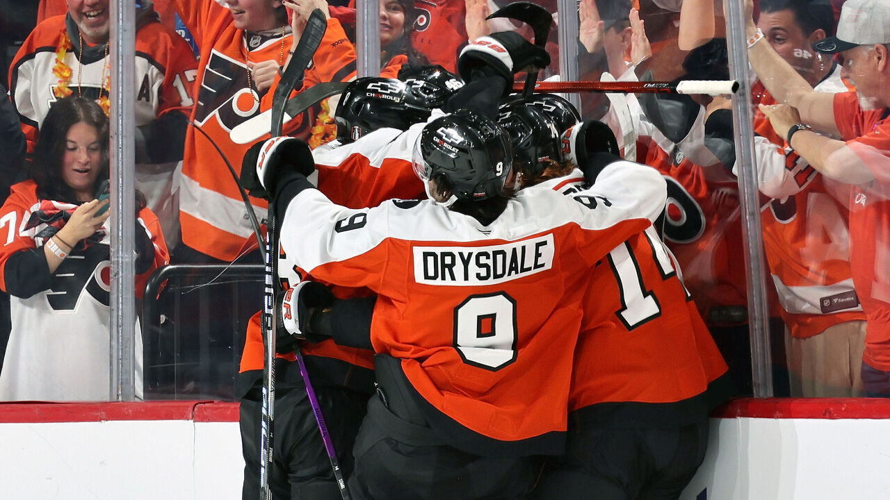 PHILADELPHIA, PENNSYLVANIA - APRIL 25: Denver Barkey #52 of the Philadelphia Flyers mobbed by teammates Cam York #8, Jamie Drysdale #9, Owen Tippett #74 and Trevor Zegras #46 following his second period goal against the Pittsburgh Penguins with Jamie Drysdale #9 and the fans along the glass in Game Four of the First Round of the 2026 Stanley Cup Playoffs at the Xfinity Mobile Arena on April 25, 2026 in Philadelphia, Pennsylvania.