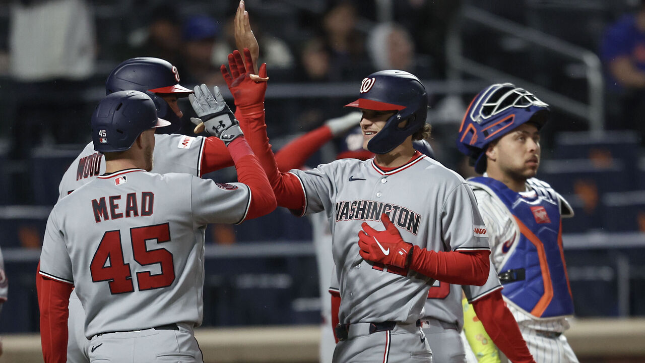 NEW YORK, NEW YORK - APRIL 29: Brady House #12 of the Washington Nationals, center, celebrate with teammates at home plate after he hits a grand slam during the fourth inning of a game against the New York Mets at Citi Field on April 29, 2026 in the Queens borough of New York City.