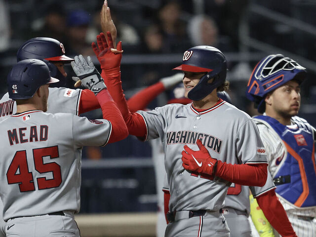 NEW YORK, NEW YORK - APRIL 29: Brady House #12 of the Washington Nationals, center, celebrate with teammates at home plate after he hits a grand slam during the fourth inning of a game against the New York Mets at Citi Field on April 29, 2026 in the Queens borough of New York City.