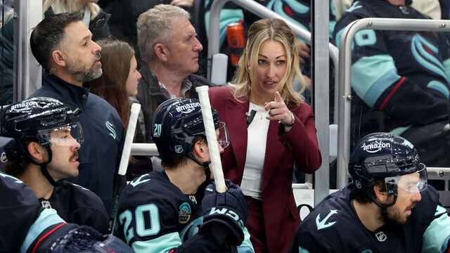 SEATTLE, WASHINGTON - MARCH 10: Assistant Jessica Campbell of the Seattle Kraken talks with Eeli Tolvanen #20 during the second period against the Nashville Predators at Climate Pledge Arena on March 10, 2026 in Seattle, Washington.
