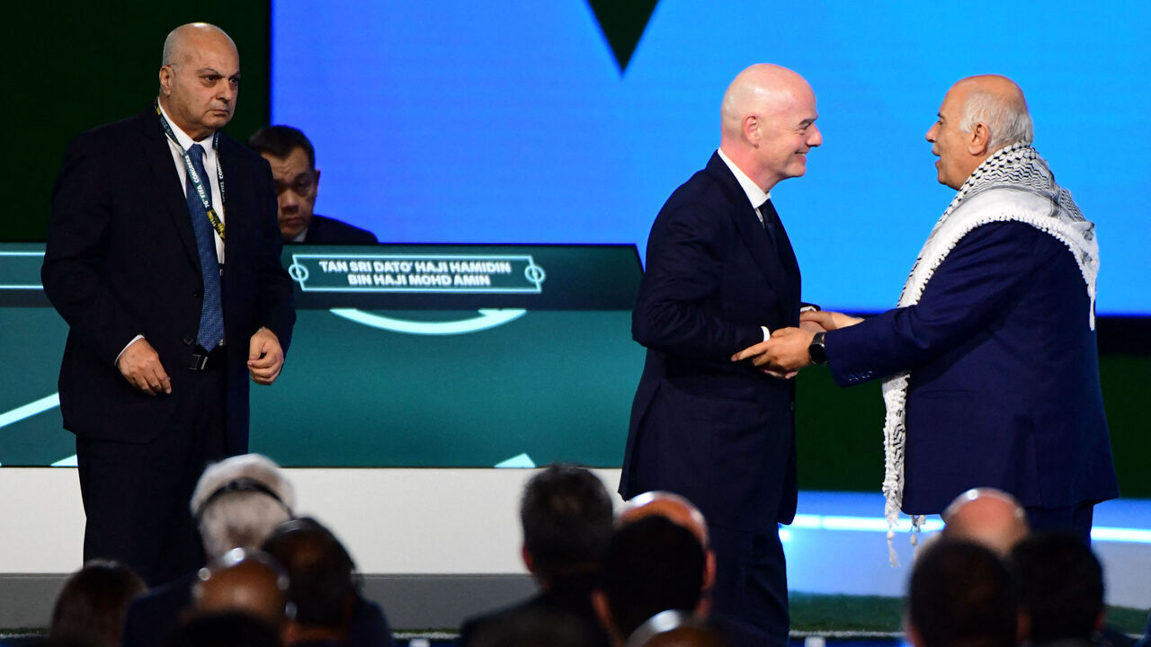 FIFA President Gianni Infantino (C) interacts with the President of the Palestine Football Association Jibril Rajoub as the Vice-President of Israel Football Association Basim Sheikh Suliman (L) looks on during a heated moment in the 76th FIFA Congress in Vancouver, Canada on April 30, 2026.