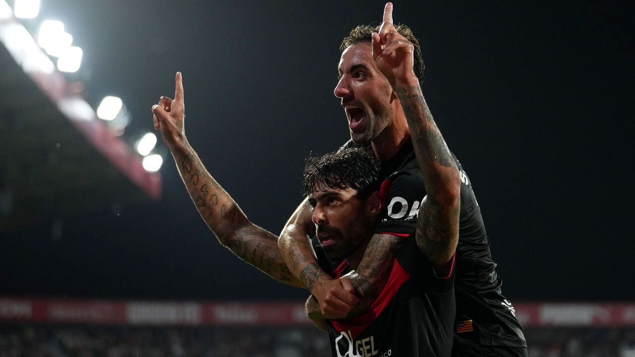 GIRONA, SPAIN - MAY 01: Samu Costa of RCD Mallorca celebrates scoring his team's first goal with teammate Sergi Darder during the LaLiga EA Sports match between Girona FC and RCD Mallorca at Montilivi Stadium on May 01, 2026 in Girona, Spain.