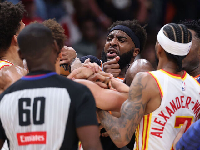 ATLANTA, GEORGIA - APRIL 30: Mitchell Robinson #23 of the New York Knicks and Jalen Johnson #1 of the Atlanta Hawks fight during the second quarter in Game Six of the First Round of the NBA Eastern Conference Playoffs at State Farm Arena on April 30, 2026 in Atlanta, Georgia.
