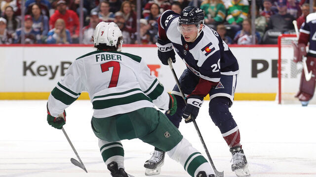 DENVER, COLORADO - MARCH 08: Ross Colton #20 of the Colorado Avalanche skates against Brock Faber #7 of the Minnesota Wild at Ball Arena at Ball Arena on March 08, 2026 in Denver, Colorado.