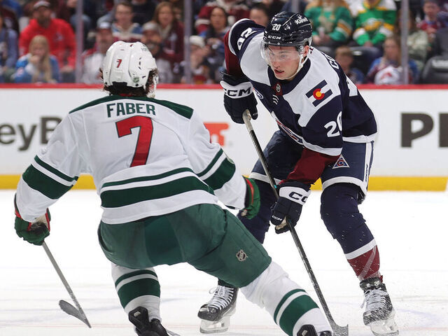 DENVER, COLORADO - MARCH 08: Ross Colton #20 of the Colorado Avalanche skates against Brock Faber #7 of the Minnesota Wild at Ball Arena at Ball Arena on March 08, 2026 in Denver, Colorado.