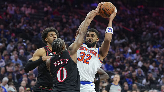 PHILADELPHIA, PENNSYLVANIA - FEBRUARY 11: Karl-Anthony Towns #32 of the New York Knicks controls the ball against Tyrese Maxey #0 of the Philadelphia 76ers in the third quarter at Xfinity Mobile Arena on February 11, 2026 in Philadelphia, Pennsylvania. The Knicks defeated the 76ers 138-89.