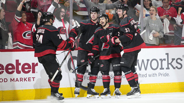 RALEIGH, NORTH CAROLINA - MAY 02: Logan Stankoven #22 of the Carolina Hurricanes is congratulated by his teammates after scoring a goal against the Philadelphia Flyers during the second period in Game One of the Second Round of the 2026 Stanley Cup Playoffs at Lenovo Center on May 02, 2026 in Raleigh, North Carolina.