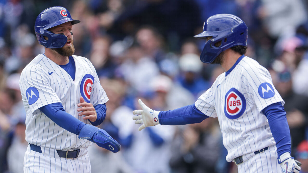 CHICAGO, ILLINOIS - MAY 3: Michael Busch #29 of the Chicago Cubs is congratulated after scoring by Dansby Swanson #7 of the Chicago Cubs in the bottom of the 2nd inning against the Arizona Diamondbacks at Wrigley Field on May 3, 2026 in Chicago, Illinois.