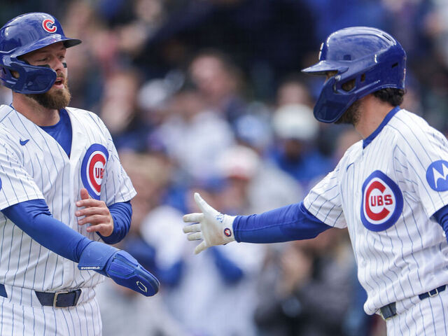 CHICAGO, ILLINOIS - MAY 3: Michael Busch #29 of the Chicago Cubs is congratulated after scoring by Dansby Swanson #7 of the Chicago Cubs in the bottom of the 2nd inning against the Arizona Diamondbacks at Wrigley Field on May 3, 2026 in Chicago, Illinois.