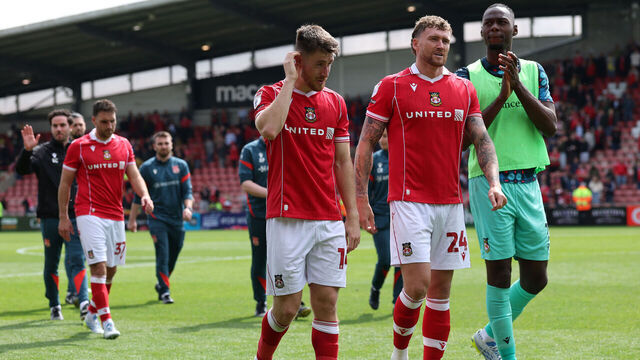 WREXHAM, WALES - MAY 02: George Thomason (l) Dan Scarr (c) and Arthur Okonkwo (r) of Wrexham show their disappointment after Wrexham failed to make the Play-Offs following the Sky Bet Championship match between Wrexham AFC and Middlesbrough at Racecourse Ground on May 02, 2026 in Wrexham, Wales.