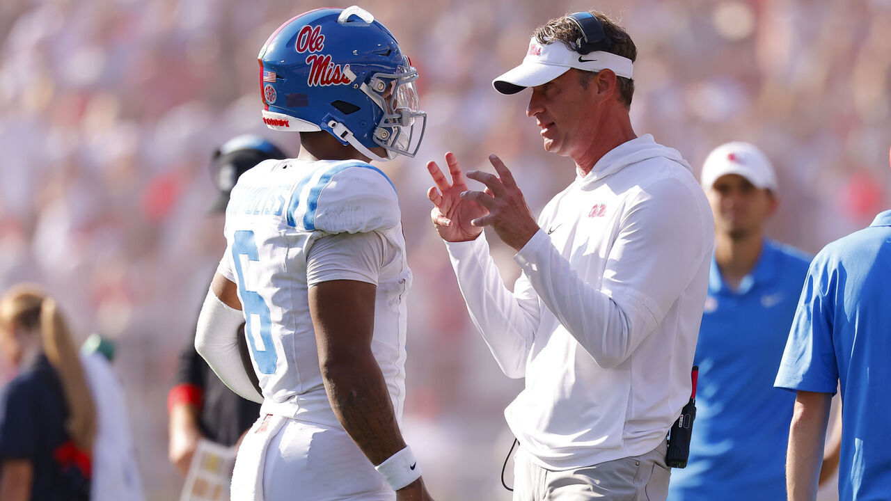 ATHENS, GEORGIA - OCTOBER 18: Head coach Lane Kiffin of the Mississippi Rebels speaks with Trinidad Chambliss #6 during the second quarter against the Georgia Bulldogs at Sanford Stadium on October 18, 2025 in Athens, Georgia.