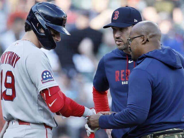 DETROIT, MICHIGAN - MAY 4: Roman Anthony #19 of the Boston Red Sox has his hand examined by trainer Brandon Henry (R) as interim manager Chad Tracy #17 (C) looks on during the first inning of a game against the Detroit Tigers at Comerica Park on May 4, 2026 in Detroit, Michigan.