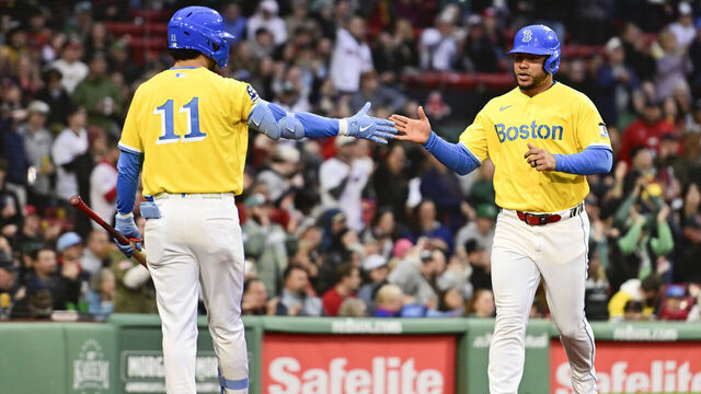 BOSTON, MASSACHUSETTS - MAY 02: Willson Contreras #40 of the Boston Red Sox is greeted at home by Marcelo Mayer #11 after scoring off a single that was hit by Wilyer Abreu #52 (not pictured) during the seventh inning against the Houston Astros at Fenway Park on May 02, 2026 in Boston, Massachusetts.