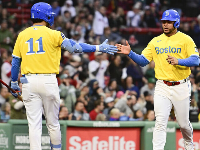 BOSTON, MASSACHUSETTS - MAY 02: Willson Contreras #40 of the Boston Red Sox is greeted at home by Marcelo Mayer #11 after scoring off a single that was hit by Wilyer Abreu #52 (not pictured) during the seventh inning against the Houston Astros at Fenway Park on May 02, 2026 in Boston, Massachusetts.
