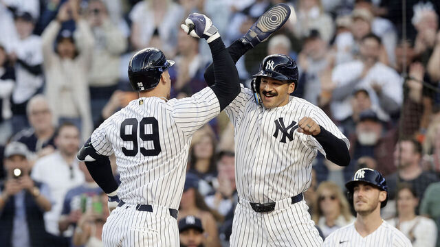 NEW YORK, NEW YORK - MAY 04: Aaron Judge #99 of the New York Yankees is congratulated by Trent Grisham #12 after his first inning two-run home run against the Baltimore Orioles at Yankee Stadium on May 04, 2026, in the Bronx borough of New York City.