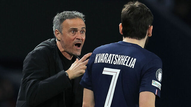 Paris Saint-Germain's Spanish headcoach Luis Enrique (L) reacts as he speaks with Paris Saint-Germain's Georgian forward #07 Khvicha Kvaratskhelia (R) during the UEFA Champions League play-off second leg football match between Paris Saint-Germain (PSG) and AS Monaco at the Parc des Princes stadium in Paris on February 25, 2026.