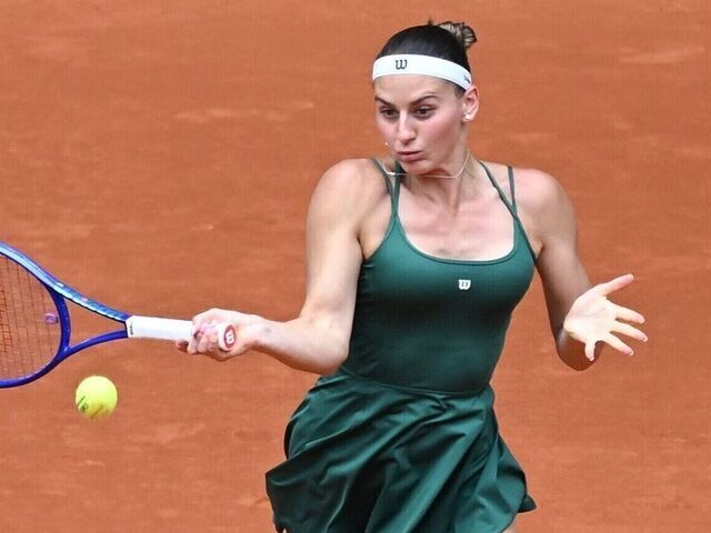 Marta Kostyuk of Ukraine hits a return during the women's singles final between Marta Kostyuk of Ukraine and Mirra Andreeva of Russia at the 2026 Madrid Open tennis tournament in Madrid, Spain, May 2, 2026.