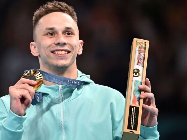 Gold medalist Individual Neutral Athlete Ivan Litvinovich poses for photos during the vistory ceremony of men's trampoline gymnastics at the Paris 2024 Olympic Games in Paris, France, Aug. 2, 2024.