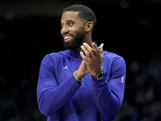 DETROIT, MICHIGAN - FEBRUARY 09: Head Coach Charles Lee of the Charlotte Hornets claps and smiles against the Detroit Pistons at Little Caesars Arena on February 09, 2025 in Detroit, Michigan.
