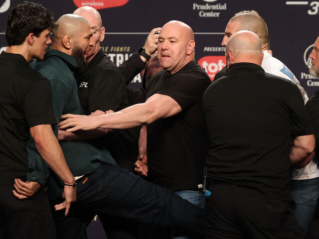 NEWARK, NEW JERSEY - MAY 07: (L-R) Khamzat Chimaev of Russia kicks Sean Strickland during a face off on stage at the UFC 328 press conference at Prudential Center on May 07, 2026 in Newark, New Jersey.