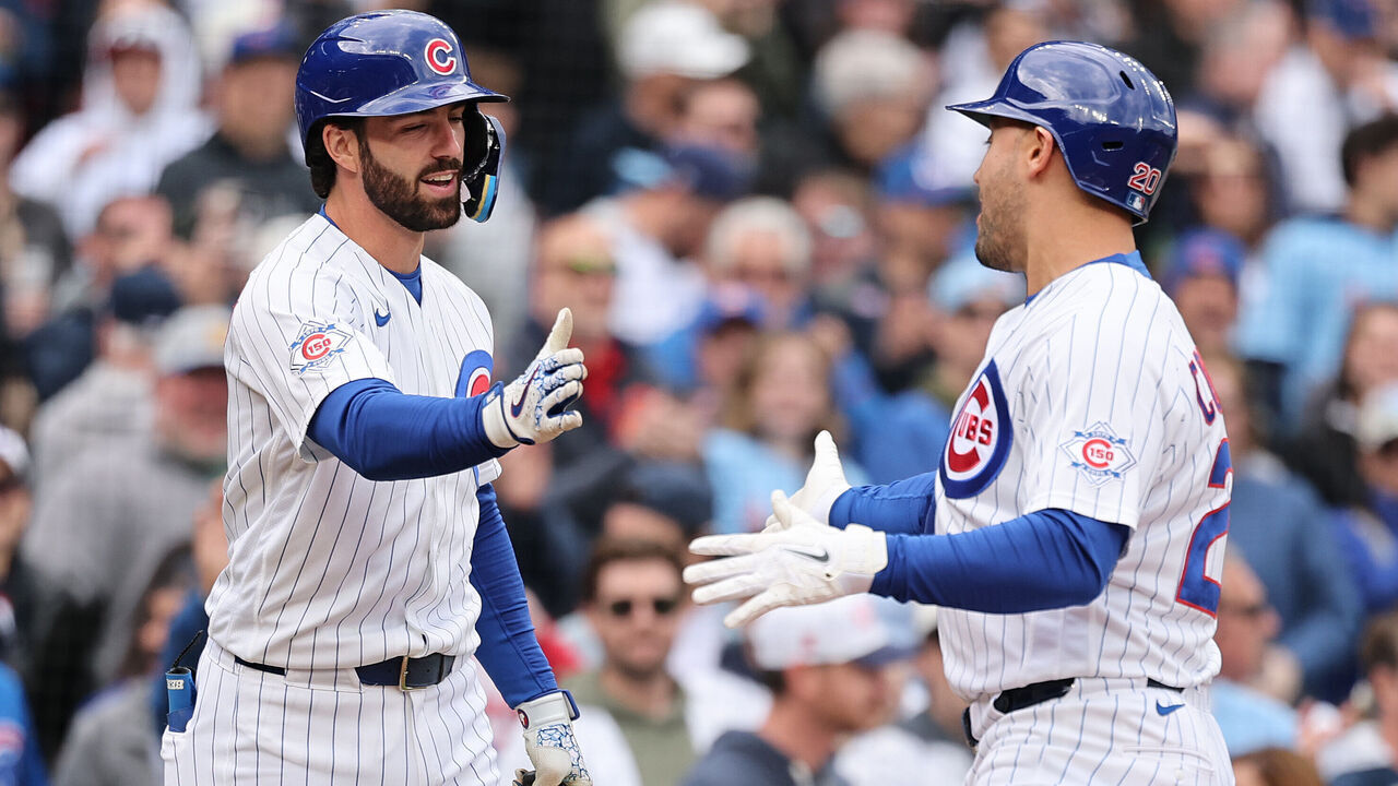 CHICAGO, ILLINOIS - MAY 07: Michael Conforto #20 of the Chicago Cubs high fives Dansby Swanson #7 after hitting a home run against the Cincinnati Reds during the second inning at Wrigley Field on May 07, 2026 in Chicago, Illinois.