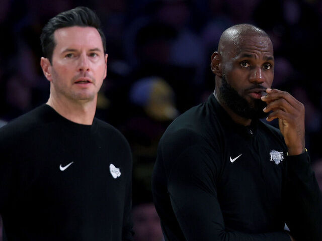 LOS ANGELES, CALIFORNIA - APRIL 12: LeBron James #23 of the Los Angeles Lakers and head coach JJ Redick watch from the sidelines during the first half against the Utah Jazz at Crypto.com Arena on April 12, 2026 in Los Angeles, California.