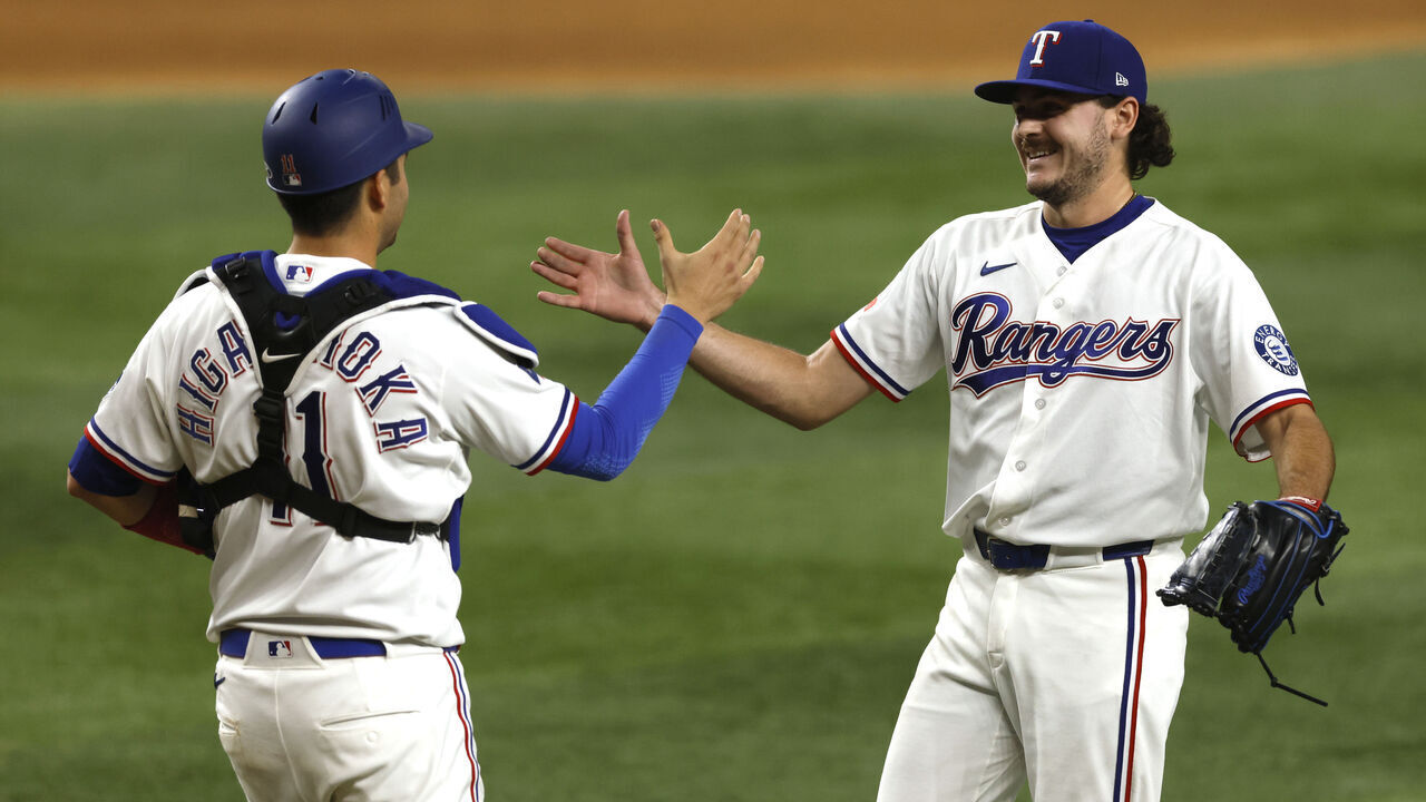 ARLINGTON, TEXAS - MAY 9: Gavin Collyer #65 of the Texas Rangers and teammate Kyle Higashioka #11 celebrate following the win over the Chicago Cubs at Globe Life Field on May 9, 2026 in Arlington, Texas.