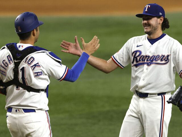 ARLINGTON, TEXAS - MAY 9: Gavin Collyer #65 of the Texas Rangers and teammate Kyle Higashioka #11 celebrate following the win over the Chicago Cubs at Globe Life Field on May 9, 2026 in Arlington, Texas.