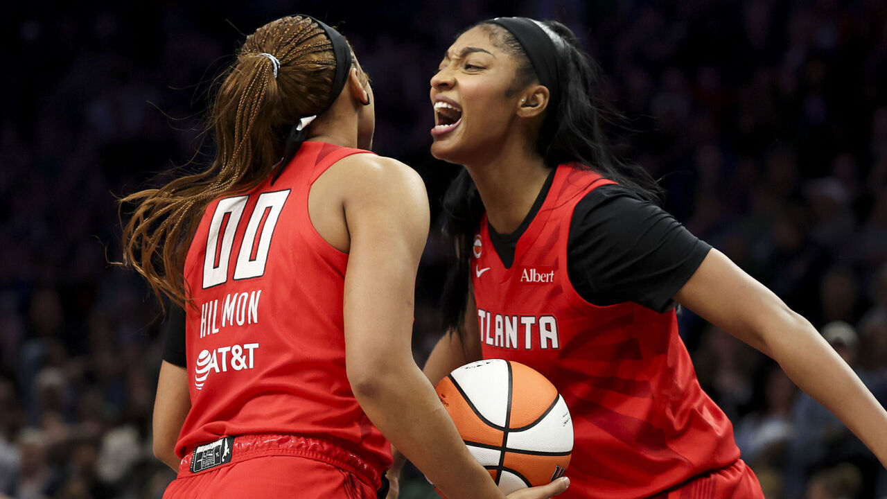 MINNEAPOLIS, MINNESOTA - MAY 09: Naz Hillmon #00 of the Atlanta Dream celebrates with teammate Angel Reese #5 after scoring a basket as Nia Coffey #12 of the Minnesota Lynx looks on during the fourth quarter at Target Center on May 09, 2026 in Minneapolis, Minnesota.
