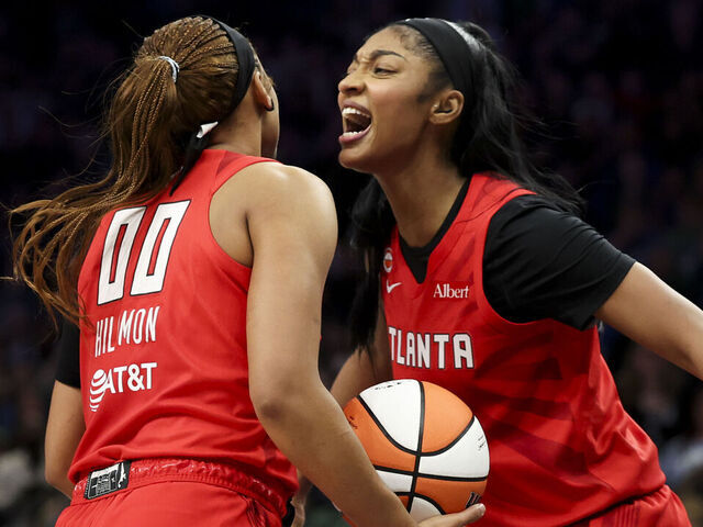 MINNEAPOLIS, MINNESOTA - MAY 09: Naz Hillmon #00 of the Atlanta Dream celebrates with teammate Angel Reese #5 after scoring a basket as Nia Coffey #12 of the Minnesota Lynx looks on during the fourth quarter at Target Center on May 09, 2026 in Minneapolis, Minnesota.