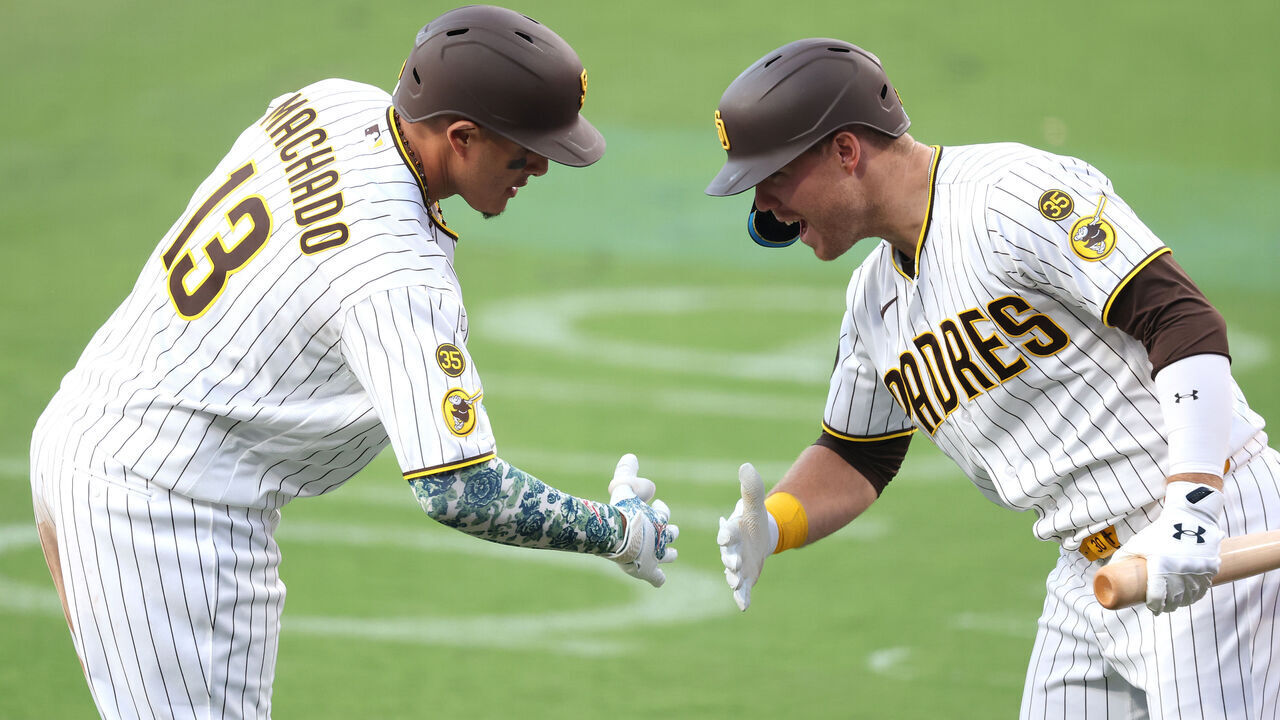 SAN DIEGO, CALIFORNIA - MAY 09: Gavin Sheets #30 congratulates Manny Machado #13 of the San Diego Padres reacts after his solo homerun during the eighth inning of a game against the St. Louis Cardinals at Petco Park on May 09, 2026 in San Diego, California.