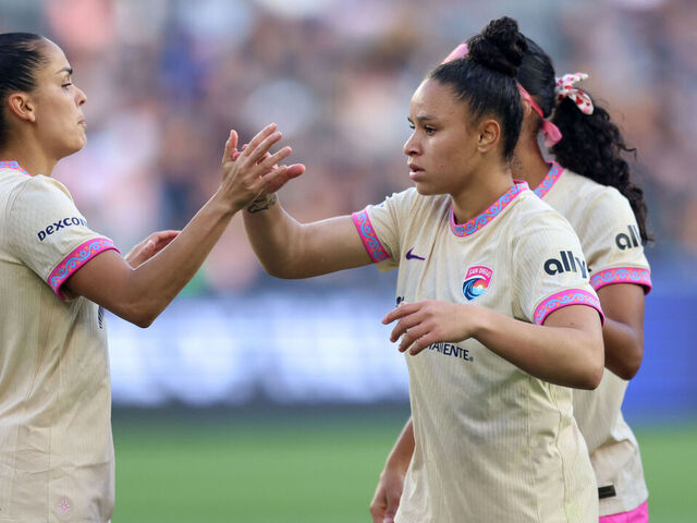 LOS ANGELES, CALIFORNIA - MAY 09: Dudinha #88 of San Diego Wave FC celebrates scoring her team's first goal with teammates Gabi Portilho #81 and Amelia Van Zanten #16 during the NWSL match between Angel City FC and San Diego Wave FC at BMO Stadium on May 09, 2026 in Los Angeles, California.