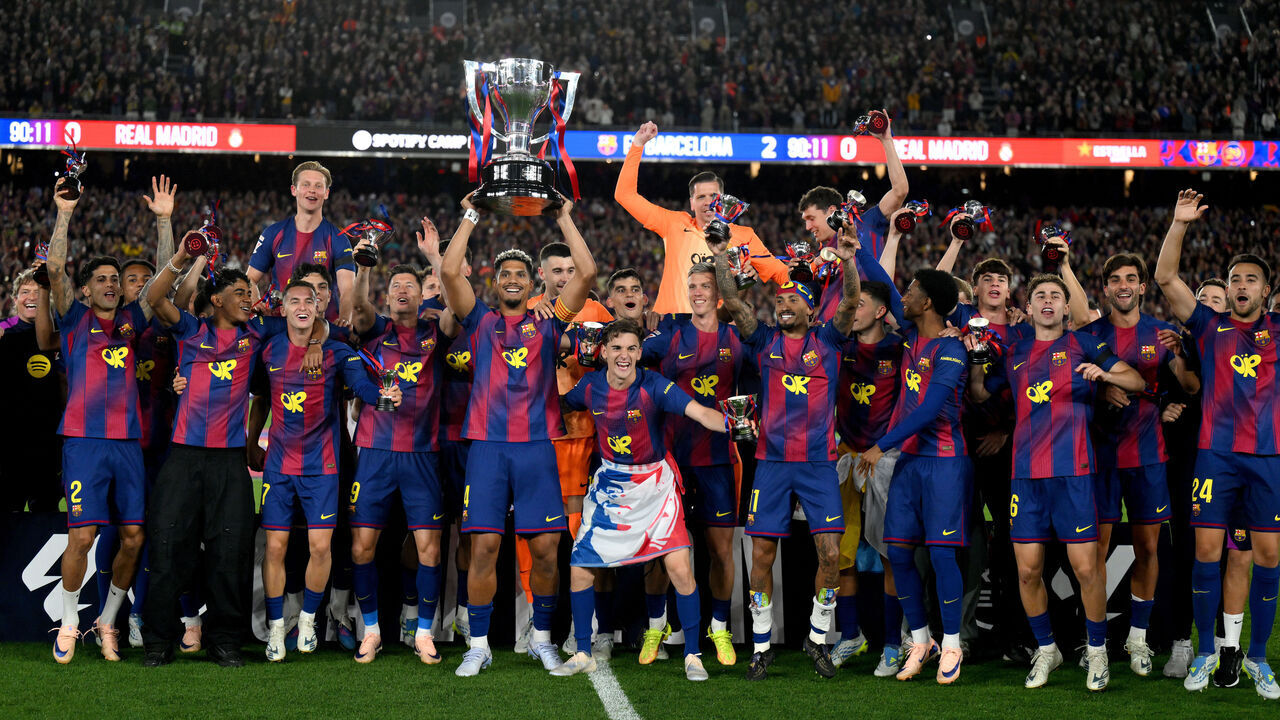 BARCELONA, SPAIN - MAY 10: Ronald Araujo of FC Barcelona lifts the LaLiga EA Sports trophy as players of FC Barcelona celebrate, after defeating Real Madrid to secure the title, after the LaLiga EA Sports match between FC Barcelona and Real Madrid CF at Spotify Camp Nou on May 10, 2026 in Barcelona, Spain.