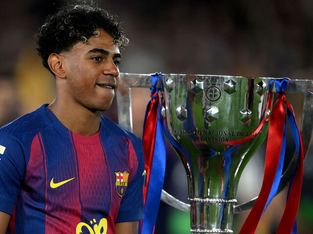 BARCELONA, SPAIN - MAY 10: Lamine Yamal of FC Barcelona who missed the match due to injury walks past the LaLiga EA Sports trophy as he makes his way to the winners podium after defeating Real Madrid, and winning the LaLiga title, after the LaLiga EA Sports match between FC Barcelona and Real Madrid CF at Spotify Camp Nou on May 10, 2026 in Barcelona, Spain.