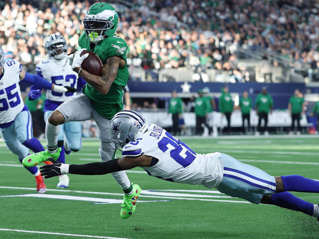 ARLINGTON, TEXAS - NOVEMBER 23: DeVonta Smith #6 of the Philadelphia Eagles is brought down by DaRon Bland #26 of the Dallas Cowboys during a game at AT&T Stadium on November 23, 2025 in Arlington, Texas.