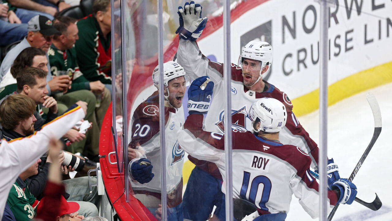 ST PAUL, MINNESOTA - MAY 11: Ross Colton #20 of the Colorado Avalanche celebrates with Brock Nelson #11 and Nicolas Roy #10 after scoring a goal against Jesper Wallstedt #30 of the Minnesota Wild during the third period in Game Four of the Second Round of the 2026 Stanley Cup Playoffs at Grand Casino Arena on May 11, 2026 in St Paul, Minnesota.