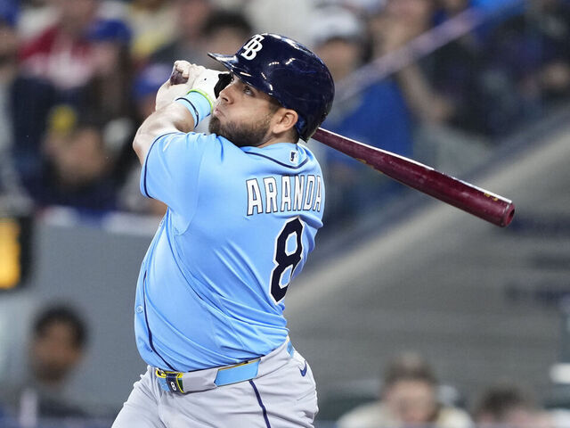 TORONTO, CANADA - MAY 11: Jonathan Aranda #8 of the Tampa Bay Rays hits an RBI sacrifice fly against the Toronto Blue Jays during the first inning in their MLB game at the Rogers Centre on May 11, 2026 in Toronto, Ontario, Canada.