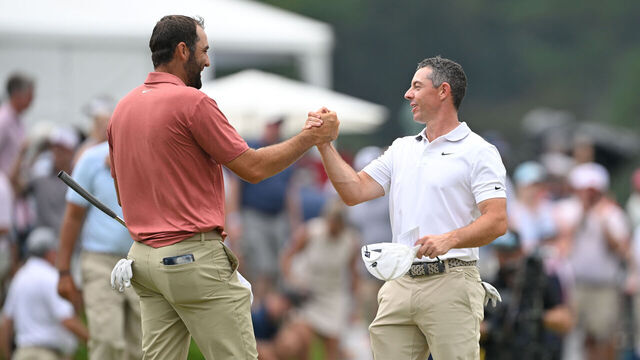 ATLANTA, GEORGIA - AUGUST 21: Scottie Scheffler and Rory McIlroy of Northern Ireland shake hands on the 18th green during the first round of the TOUR Championship at East Lake Golf Club on August 21, 2025 in Atlanta, Georgia.