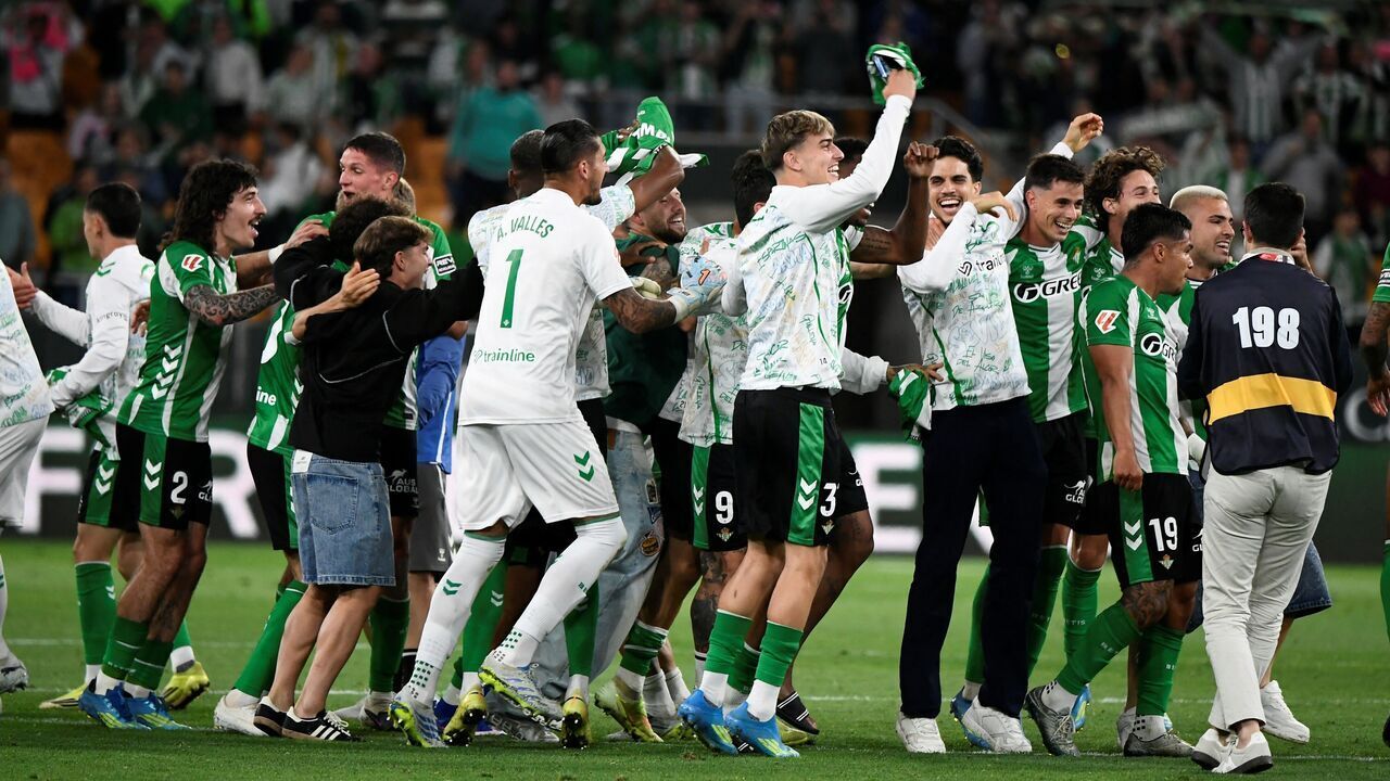 Real Betis' players celebrate at the end of the Spanish league football match between Real Betis and Elche CF at Benito Villamarin Stadium in Seville on May 12, 2026. Betis has sealed its ticket to the 2026-27 Champions League by securing LaLiga's fifth place.