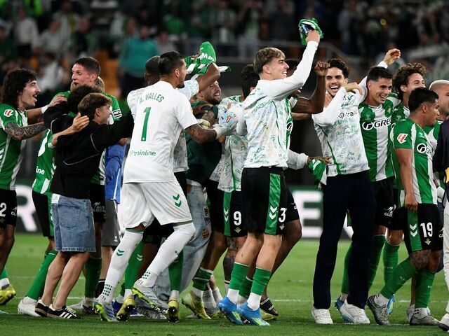 Real Betis' players celebrate at the end of the Spanish league football match between Real Betis and Elche CF at Benito Villamarin Stadium in Seville on May 12, 2026. Betis has sealed its ticket to the 2026-27 Champions League by securing LaLiga's fifth place.
