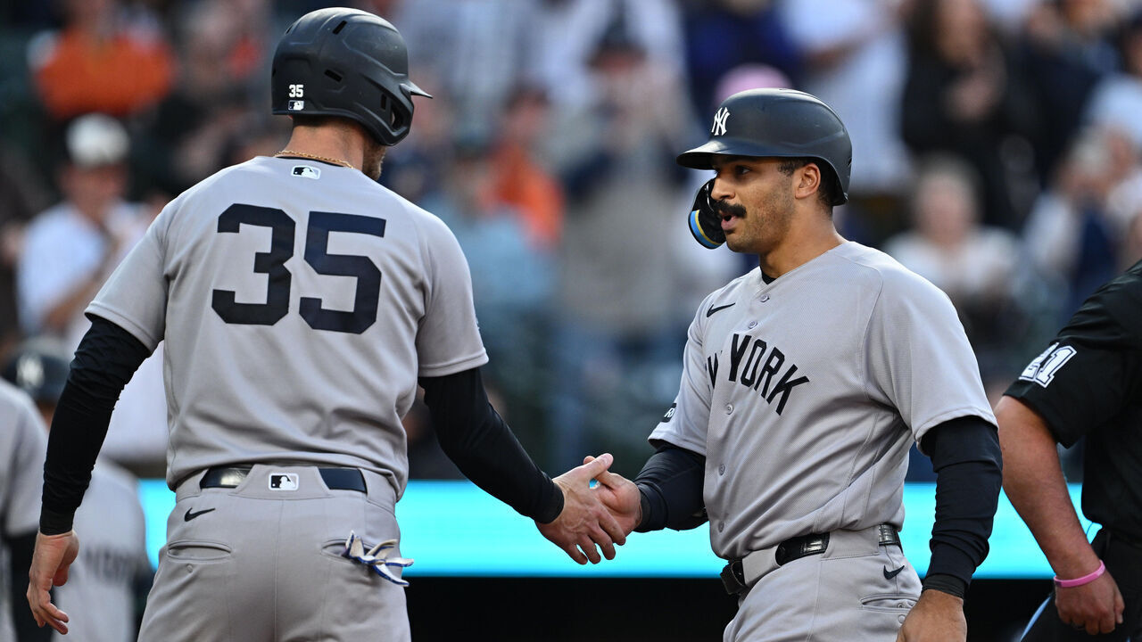 BALTIMORE, MD - MAY 12: Trent Grisham #12 of the New York Yankees, right is congratulated by Cody Bellinger #35 after hitting a three-run home run in the third inning against the Baltimore Orioles at Oriole Park at Camden Yards on May 12, 2026 in Baltimore, Maryland.