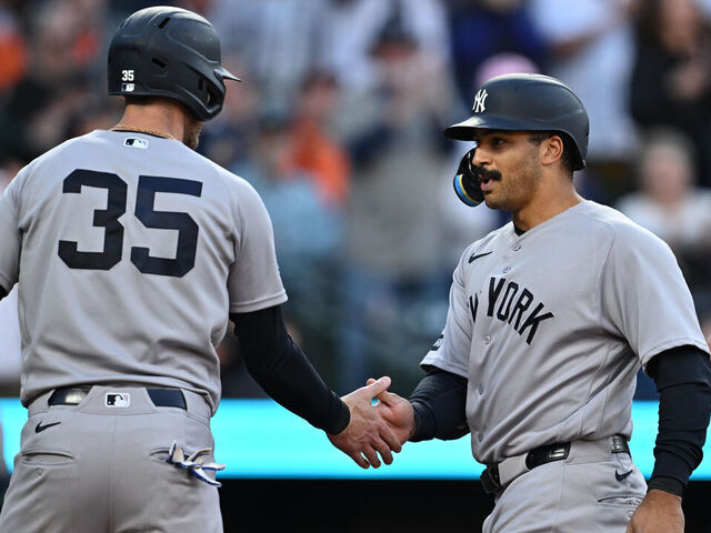 BALTIMORE, MD - MAY 12: Trent Grisham #12 of the New York Yankees, right is congratulated by Cody Bellinger #35 after hitting a three-run home run in the third inning against the Baltimore Orioles at Oriole Park at Camden Yards on May 12, 2026 in Baltimore, Maryland.