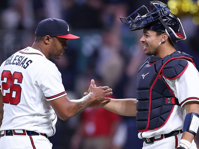 ATLANTA, GEORGIA - MAY 12: Raisel Iglesias #26 and Drake Baldwin #30 of the Atlanta Braves react after their 5-2 win over the Chicago Cubs at Truist Park on May 12, 2026 in Atlanta, Georgia.
