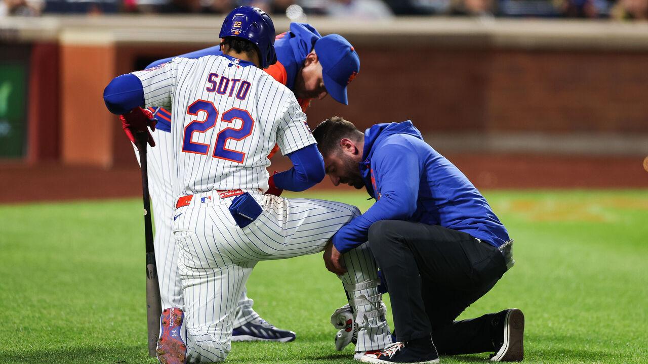 NEW YORK, NEW YORK - MAY 13: Juan Soto #22 of the New York Mets is looked at by a trainer after being hit by a pitch during the third inning against the Detroit Tigers at Citi Field on May 13, 2026 in the Queens borough of New York City.