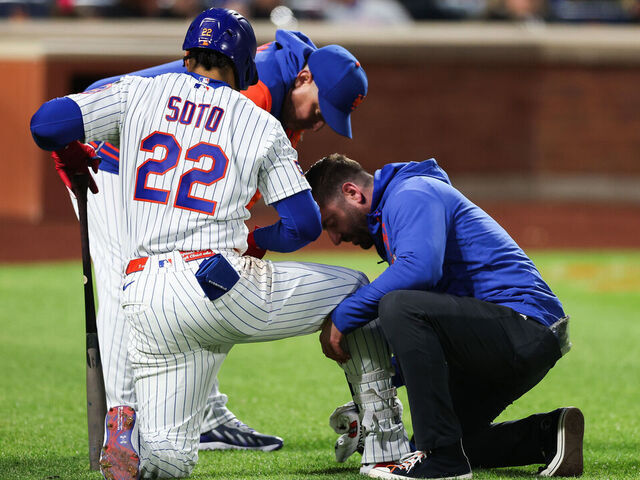NEW YORK, NEW YORK - MAY 13: Juan Soto #22 of the New York Mets is looked at by a trainer after being hit by a pitch during the third inning against the Detroit Tigers at Citi Field on May 13, 2026 in the Queens borough of New York City.