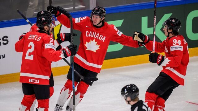 Canada's defender #2 Dylan DeMelo, Canada's forward #93 Fraser Minten and Canada's forward #94 Porter Martone celebrate their team's fourth goal during the IIHF Ice Hockey Men's World Championship first round group B ice hockey match between Canada and Sweden at the BFC Arena, in Fribourg, Switzerland on May 15, 2026.
