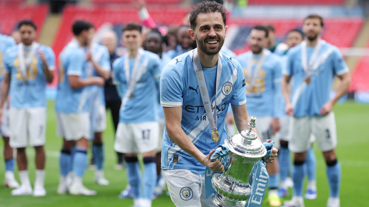 LONDON, ENGLAND - MAY 16: Bernardo Silva of Manchester City celebrates with the FA Cup trophy after the Emirates FA Cup Final match between Chelsea and Manchester City on May 16, 2026 in London, England.
