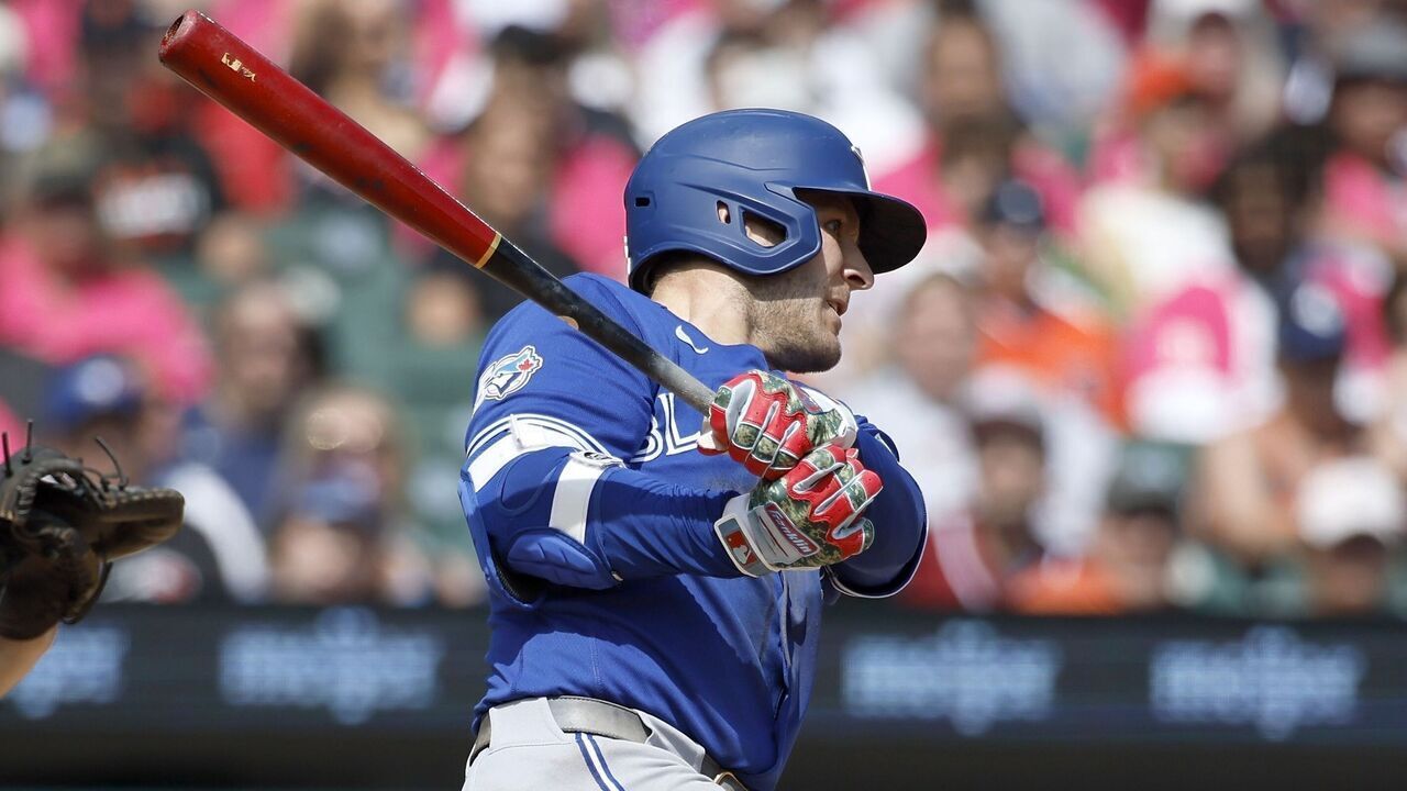 DETROIT, MI - MAY 16: Daulton Varsho #5 of the Toronto Blue Jays hits an RBI single to drive in Vladimir Guerrero Jr. and take a 2-1 lead with catcher Jake Rogers #34 of the Detroit Tigers behind the plate during the 10th inning at Comerica Park on May 16, 2026 in Detroit, Michigan.