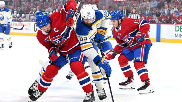 MONTREAL, CANADA - MAY 16: Nick Suzuki #14 of the Montréal Canadiens and Alex Tuch #89 of the Buffalo Sabres battle for the puck during the first period in Game Six of the Second Round of the 2026 Stanley Cup Playoffs at Bell Centre on May 16, 2026 in Montreal, Quebec, Canada.