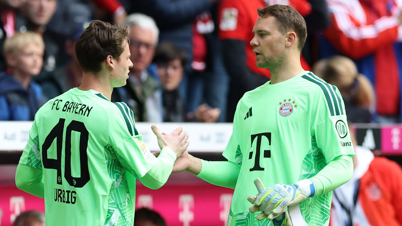 MUNICH, GERMANY - MAY 16: Jonas Urbig of FC Bayern Munich shakes hands with Manuel Neuer as he leaves the field after being substituted during the Bundesliga match between FC Bayern München and 1. FC Köln at Allianz Arena on May 16, 2026 in Munich, Germany.